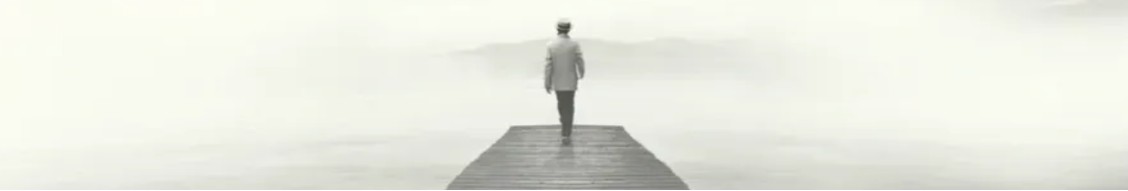 A figure walking along a wooden jetty towards an open horizon